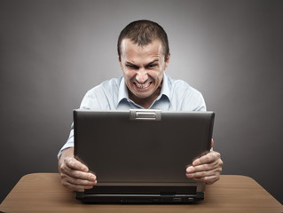 Angry businessman at laptop