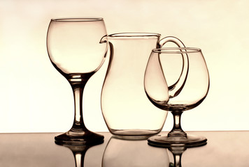 Two wineglasses and a jug on the mirror