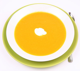 Pumpkin Soup decorated with cream on white background