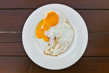 Fried egg on wood table
