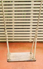 Old swing hanging in garden