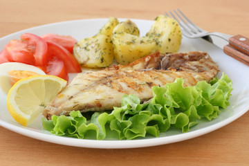 fried fish with potato and lemon