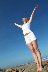 Woman stretching arms up from freedom