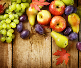 Organic Fruits over wood background. Autumn harvest