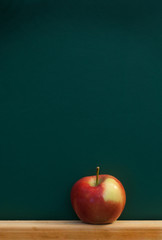 Red apple on chalkboard