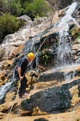 Men descending waterfall