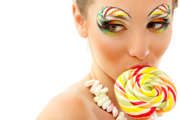 Naklejka premium woman licks candy with beautiful make-up isolated on white