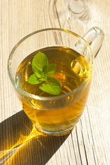 mint tea and mint leaf on old wooden table