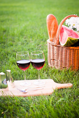 glass of red wine and picnic basket