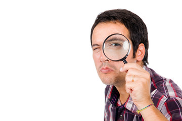 Funny image of a young man looking through magnifying glass, iso