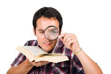 Young man reading a interesting book with magnifying glass, isol