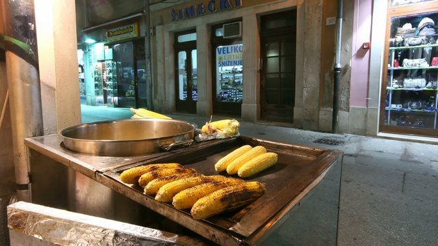People buying baked corn