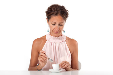 Woman drinking a coffee. White studio background.