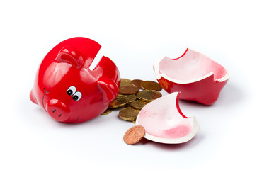 Broken piggy bank or money box with coins isolated on white