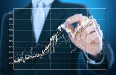 businessman writing graph of stock market