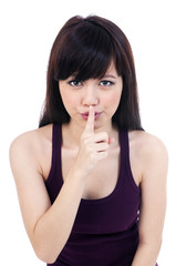 Cute young woman with finger on her lips