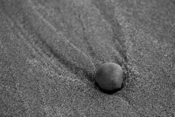 Fototapeta na wymiar Stone Making Pattern in Sand B&W