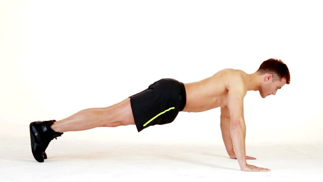 Handsome muscular man exercising on white background