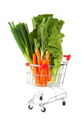 Shopping cart with vegetables over white background
