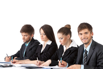young business people sitting in row at desk working