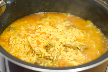 Rice, meat carrots and spices, cooking Uzbek pilaf.