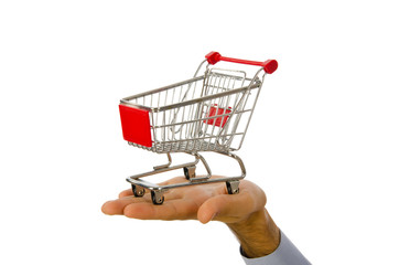 Hand holding shopping cart on white