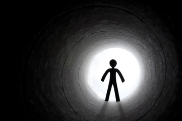Male silhouette at the end of tunnel