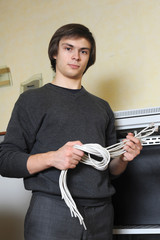 System administrator with wires in hand near server