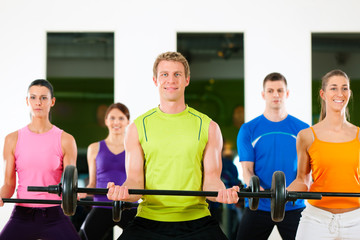 Fototapeta premium Fitness people with barbell in gym