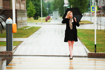 Woman with umbrella on the crosswalk