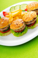 Plate with tasty mini burgers