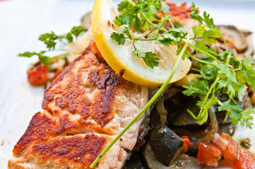 grilled salmon and lemon - french cuisine dish with tomato and s