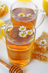 cup of herbal tea with chamomile flowers and honey -healthy life