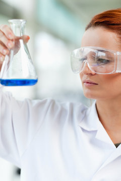 Portait of a science student looking at an Erlenmeyr flask