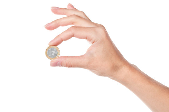 Hand holding 1 Euro coin