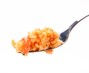 Risotto with tomatoes on a fork on white background