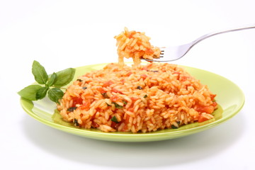 Risotto with tomatoes being eaten with a fork