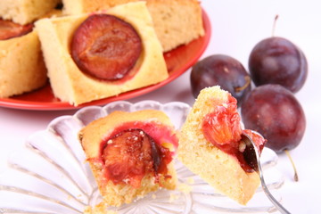 Plum Pie - a piece of it on a fork, some fresh plums