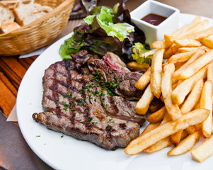 juicy steak beef meat with tomato and french fries