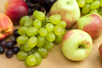 Naklejka na ściany i meble Fresh fruits, apples, grapes and peaches on the table