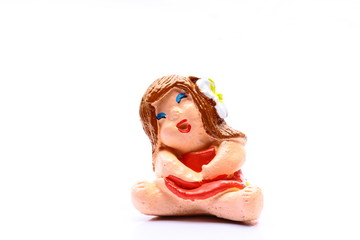 Smiling and funny girl doll from pottery
