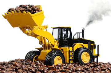 Toy excavator loads the coffee beans on white