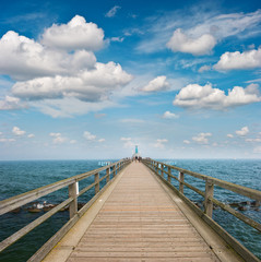 wooden jetty over sea. turquoise water and blue sky