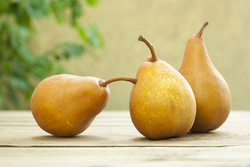 three pears on wooden table