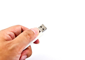 Hand holding USB storage drive.