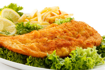 Fish dish - fried fish fillet, French fries with vegetables