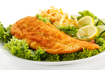 Fish dish - fried fish fillet, French fries with vegetables