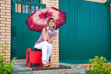 young woman with a red suitcase