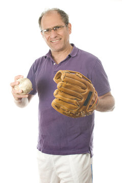 Middle Age Senior Man Softball Throwing Into Baseball Glove On