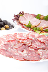 Cutting sausage and meat on a celebratory table.